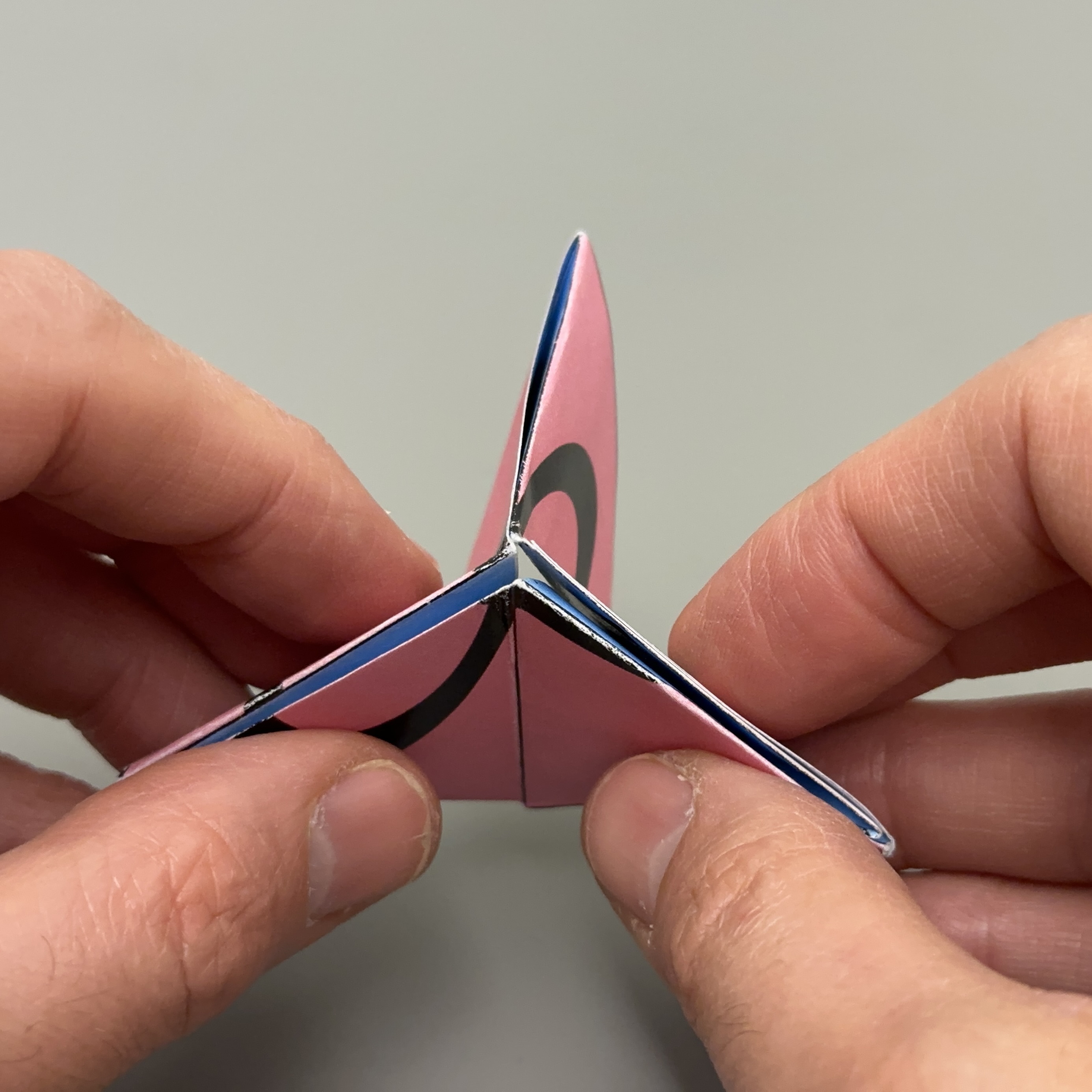 Flexagon pinched at one corner into a three-pointed star shape